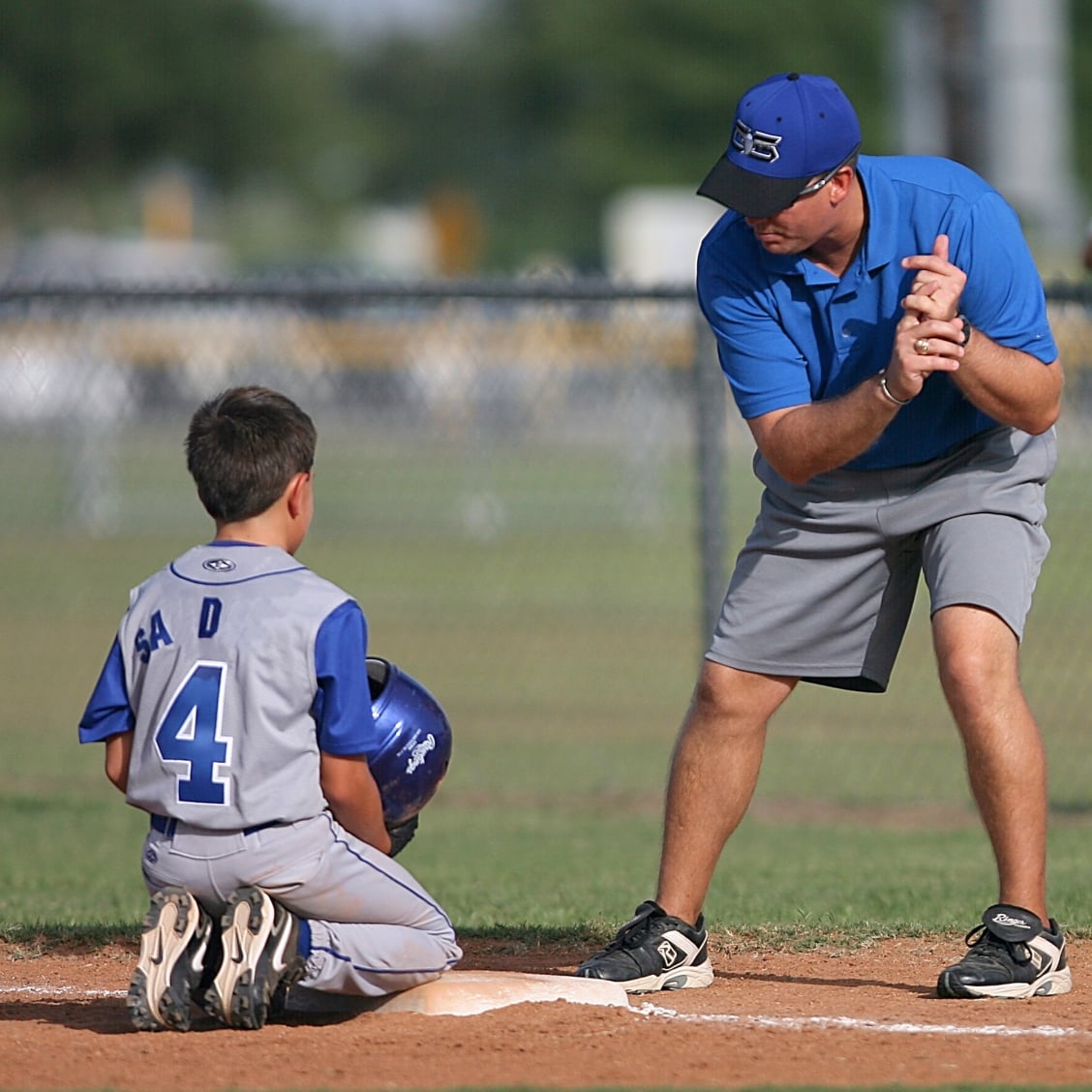 Baseball athlete sliding into base